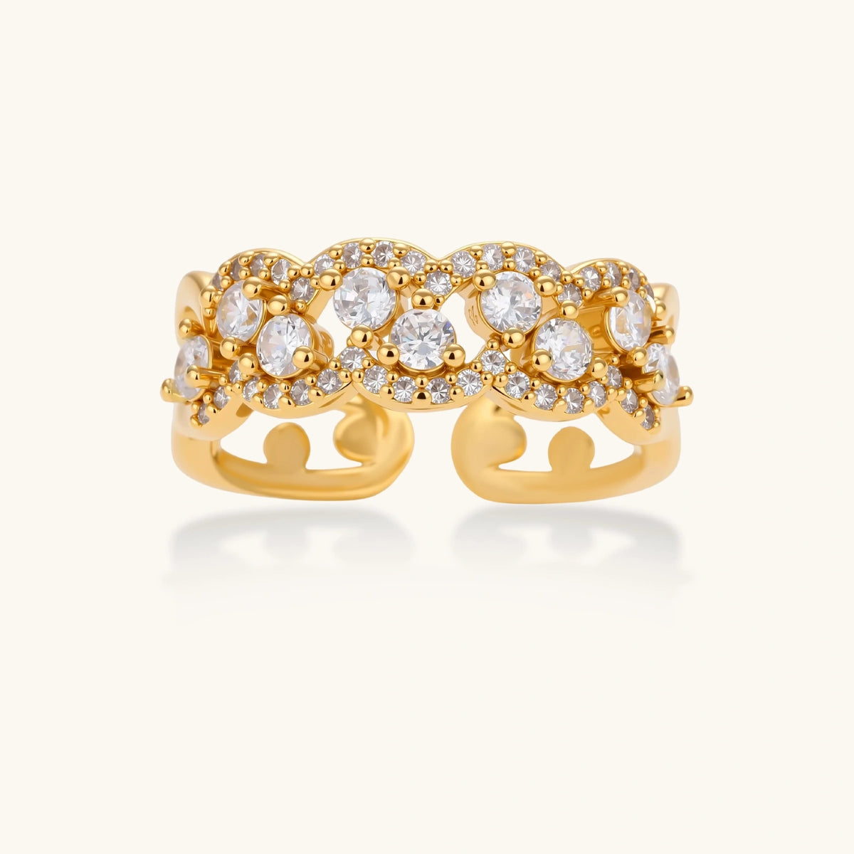 Adjustable gold-plated ring with multiple crystal clusters in intricate chain design on cream background.