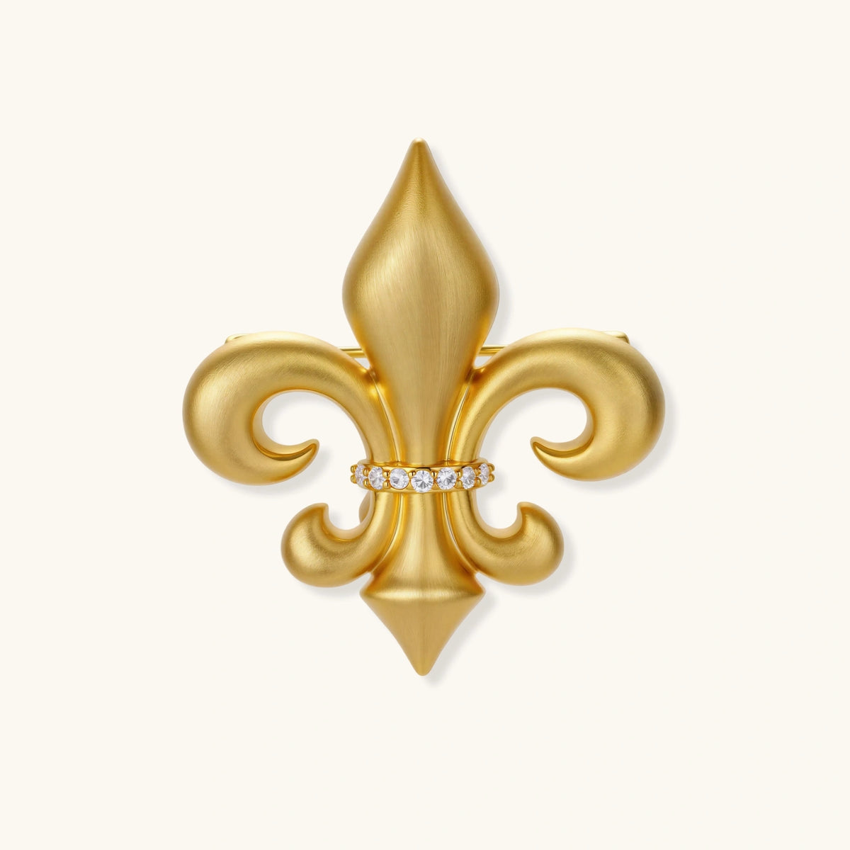 Ornate gold-plated fleur-de-lis brooch with crystal band detail on white background, showing brushed metal finish.