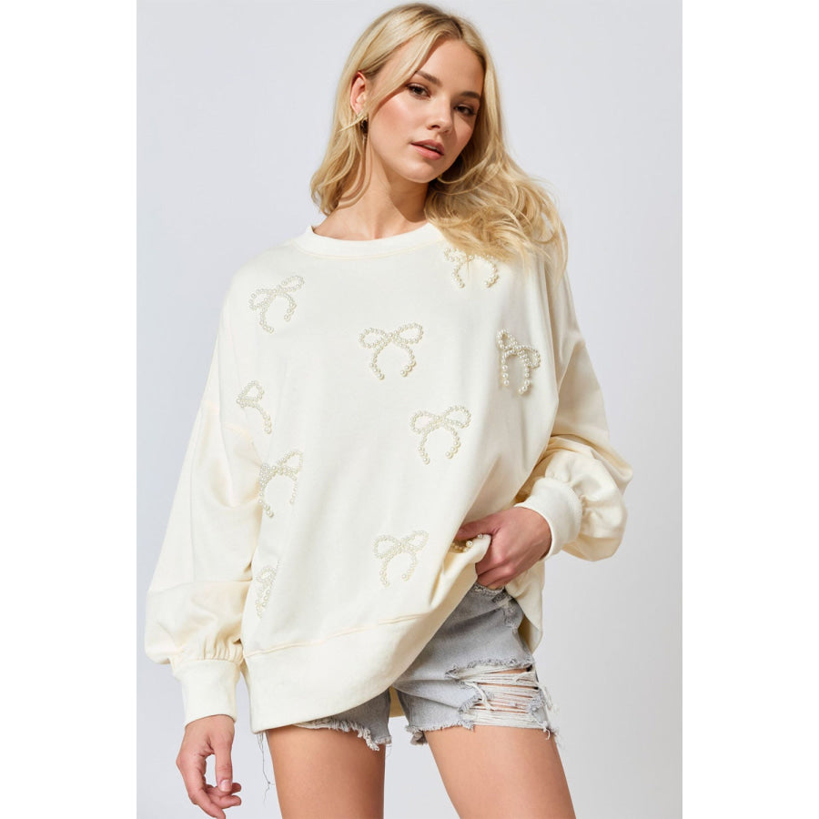 Pearl Bow Round Neck Dropped Shoulder Sweatshirt Ivory / S Apparel and Accessories